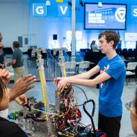 FIRST Robotics students explain robot to guests